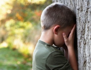 Boy-playing-hide-and-seek-against-a-tree-credit-Nick-Daly-200338569-001-630x487